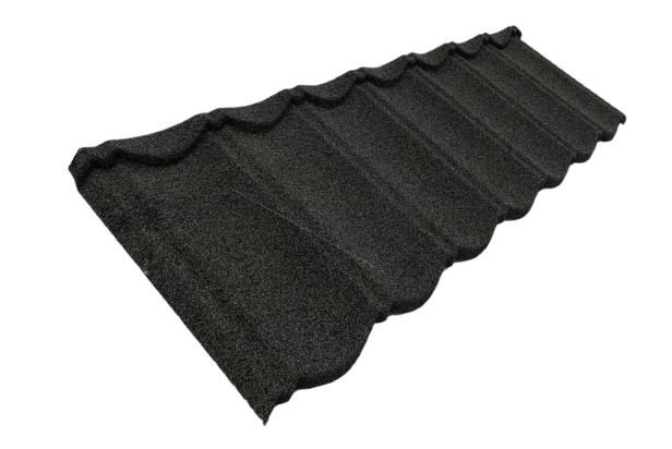 A single charcoal-gray roofing panel is isolated in the frame. It is angled diagonally and has a granular surface with parallel raised ridges forming repeated tile-like waves. The upper edge has a pronounced scalloped profile, with a far corner rising near the upper right.