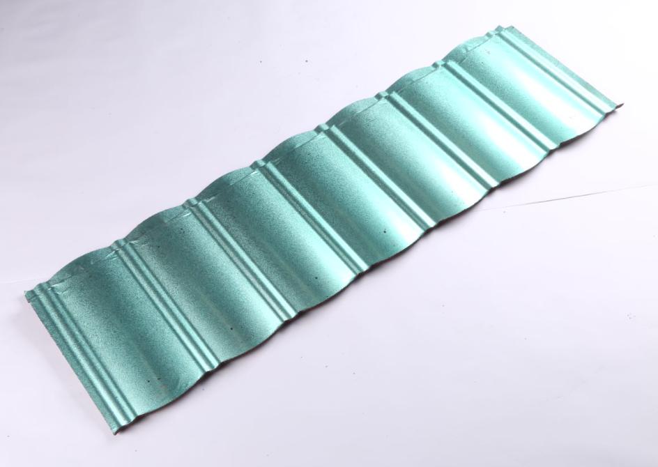 A long turquoise green-gray roof panel lies diagonally on a light background. Its reflective surface has a repeated raised profile with broad shallow channels and narrow ribs. Both ends are cut at an angle, and no other objects appear.
