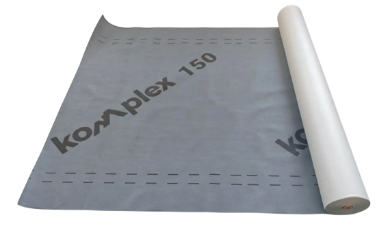 A gray sheet is partly unrolled, with its white cylindrical roll along the right edge. The sheet carries the large printed text “Komplex 150,” dashed guide lines, and a smaller partial repeat of the text near the right side. The visible sheet has a folded corner at the upper left.